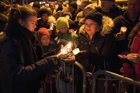 Dicht gedrängt entzünden Menschen ihre Kerzen am Friedenslicht